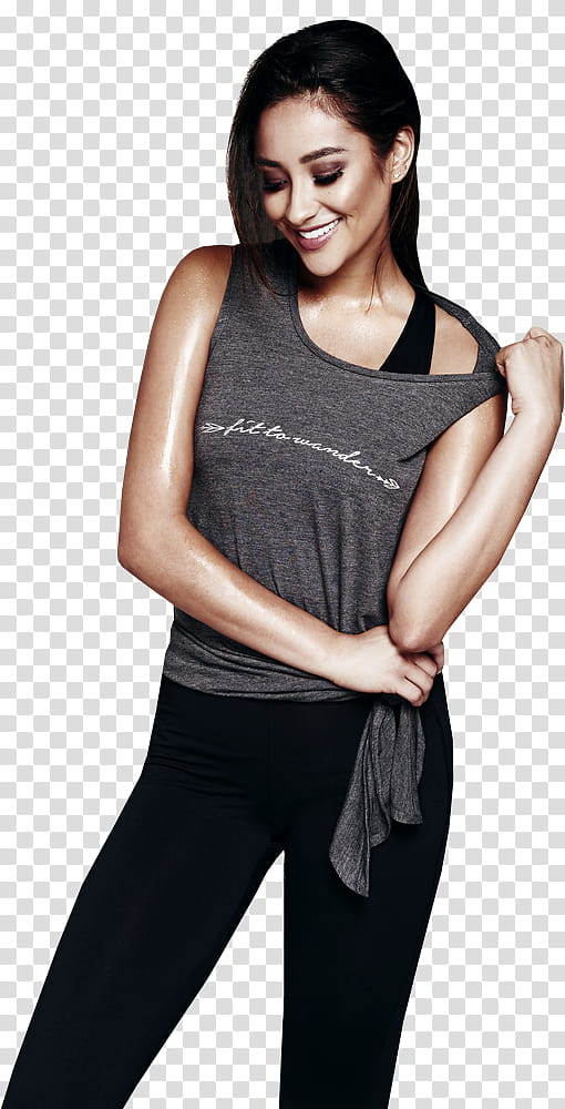 Shay Mitchell, woman wearing gray top and black pants standing inside room transparent background PNG clipart
