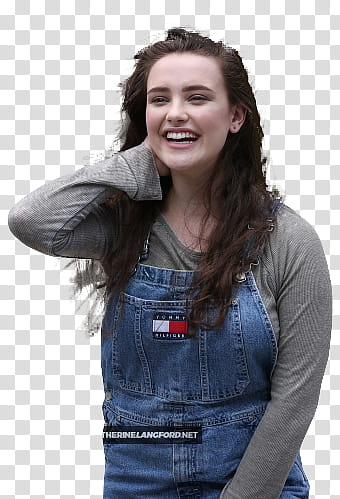 Katherine Langford, smiling woman standing and touching her neck transparent background PNG clipart