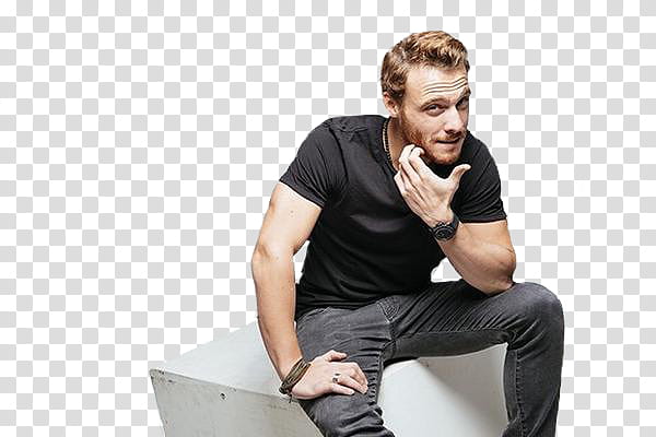 Kerem Bursin wearing black crew-neck t-shirt and gray denim jeans sitting while touching his chin transparent background PNG clipart