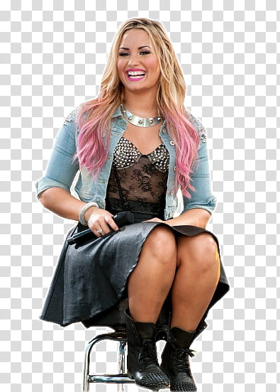 Demi Lovato , Demi Lovato sits on black and silver stool transparent background PNG clipart